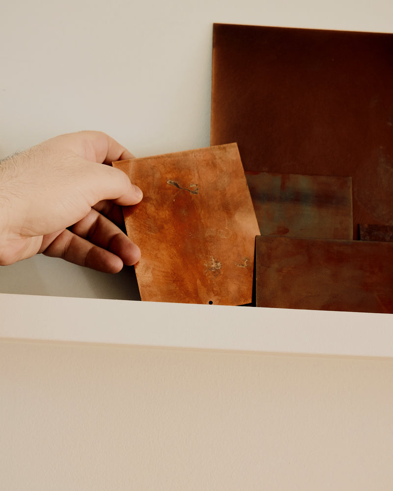Hand holding a piece of brown leather