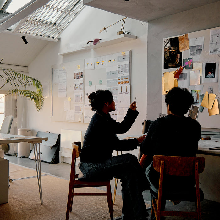 Two people sitting at a table in Atelier001 office