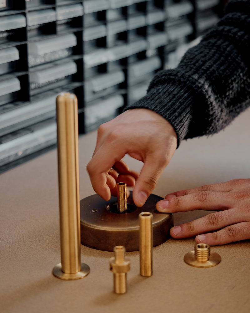person holding metal fixtures of Atelier001 light